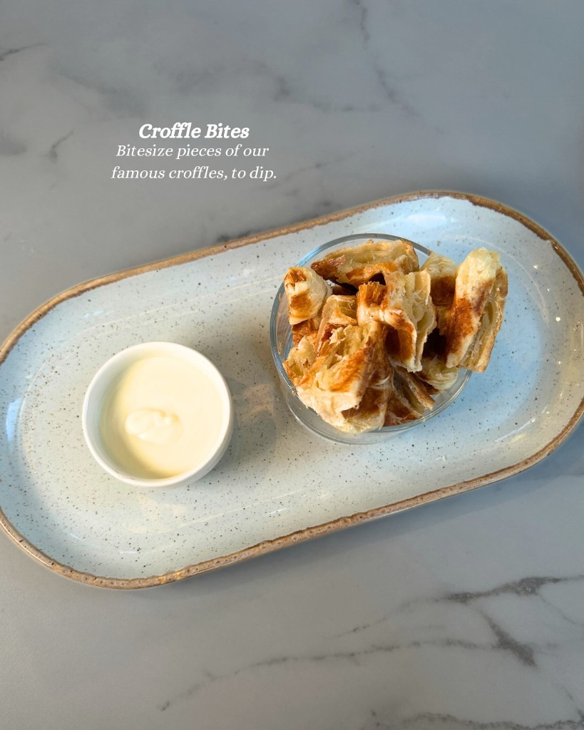 Croffle bites with dipping sauce on oval platter